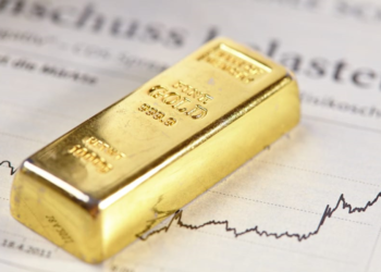 A gold bar rests on a document with financial graphs, its purity and weight inscribed. The scene evokes themes of investment, market analysis, and wealth management with Genesis Gold Group overseeing the path to prosperity. | FintechZoom