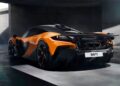 A sleek, orange and black McLaren W1 is parked in a modern, concrete-walled garage. The car features aerodynamic curves, a large rear spoiler, and dual exhausts, with natural light streaming in from above. | FintechZoom