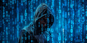 A person in a hooded jacket stands against a digital background of blue binary code. The numbers 1 and 0 are prominently displayed, evoking themes of hacking or cyber technology. The image conveys a mysterious and technological atmosphere. | FintechZoom