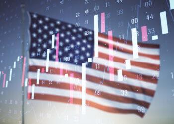 An American flag waves in the background, accented by a digital overlay of fluctuating stock market graphs and candlestick charts, symbolizing economic activity with the Producer Price Index (PPI) as a subtle yet crucial indicator. | FintechZoom