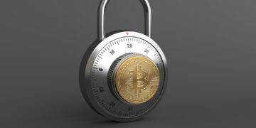 A silver combination lock with a Bitcoin symbol in the center stands against a dark gray background, evoking secure cryptocurrency practices. Discover more about safeguarding your investment with Bitcoin Security: Tips for Protecting Your Investment from FintechZoom.com. | FintechZoom