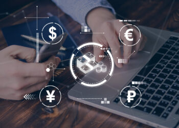 A person engages with a laptop and smartphone surrounded by digital currency symbols like dollar, euro, yen, and ruble. This scene highlights online financial technology and banking innovations as explored by FintechZoom.com, while showcasing neobanks reshaping the future of finance. | FintechZoom