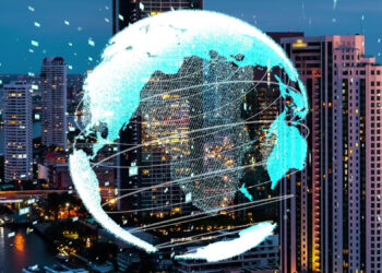 A digital globe with a glowing grid overlay is positioned over a cityscape, symbolizing the future of FinTech. Skyscrapers and lights illuminate the evening scene, creating a harmonious blend of technology, diplomacy, and urban life. | FintechZoom