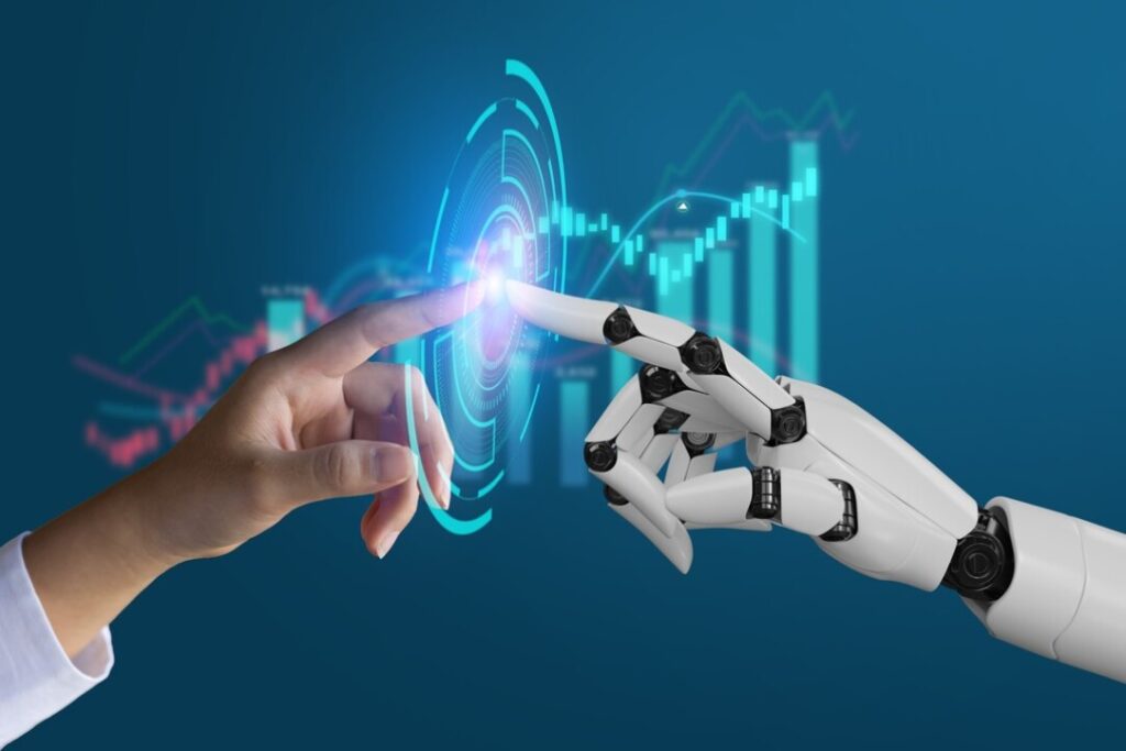 A human hand and a robotic hand touch index fingers, with glowing light at the point of contact. A digital background shows graphs and data charts, symbolizing technology and collaboration between humans and AI. | FintechZoom