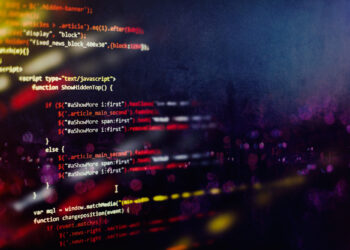 Colorful lines of JavaScript code are displayed on a blurred dark background with glowing abstract lights, capturing the vibrant and dynamic essence of software development. | FintechZoom