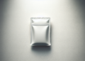 Minimalistic image of a sealed, silver-colored foil packet against a smooth, light gray gradient background. The packaging is reflective, with subtle shadows suggesting a flat and simple design. | FintechZoom