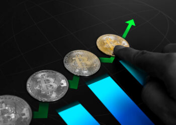 A hand points to a golden Bitcoin among silver Bitcoins, arranged along an upward green arrow and blue bar graph, symbolizing the rising value of cryptocurrency and the dynamic exchange from USDT to BTC. | FintechZoom