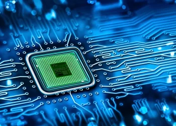 A close-up digital illustration of a microchip on a blue circuit board, with glowing lines representing electronic connections radiating outward from the central chip—a visual nod to the impact of Trump’s Semiconductor Tariffs on global tech supply chains. | FintechZoom