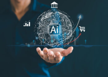 A person holds out their hand with a digital globe displaying the letters "AI" and icons for finance, statistics, and shopping, representing Studocu’s role in artificial intelligence and technology advancements. | FintechZoom