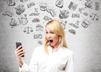 A surprised woman in a white shirt looks at her phone, with hand-drawn financial icons such as money, piggy banks, and scales swirling above her head against a gray wall. | FintechZoom