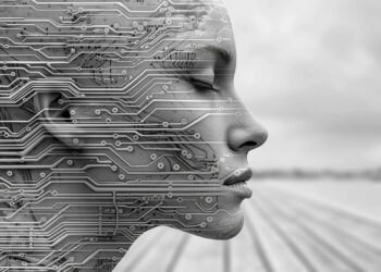 A grayscale image of a human face in profile, overlaid with intricate circuit board patterns, blending technology and human features. The background is blurred, emphasizing the face and circuitry. | FintechZoom