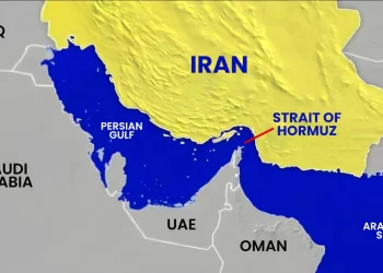 A map highlighting Iran, Iraq, Saudi Arabia, UAE, and Oman, with the Persian Gulf and Arabian Sea labeled. The Strait of Hormuz is marked with a red line and text, showing its location between Iran and the UAE/Oman. | FintechZoom