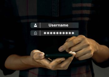A person holding a smartphone and entering login credentials, with digital overlays showing "Username" and a password field filled with asterisks, illustrates how No-KYC Platforms Are Reshaping User Trust in Digital Transactions. | FintechZoom