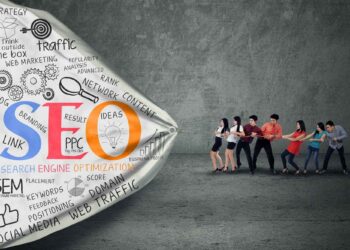 A group of people play tug-of-war with a cloth covered in SEO-related words and concepts on a gray background.