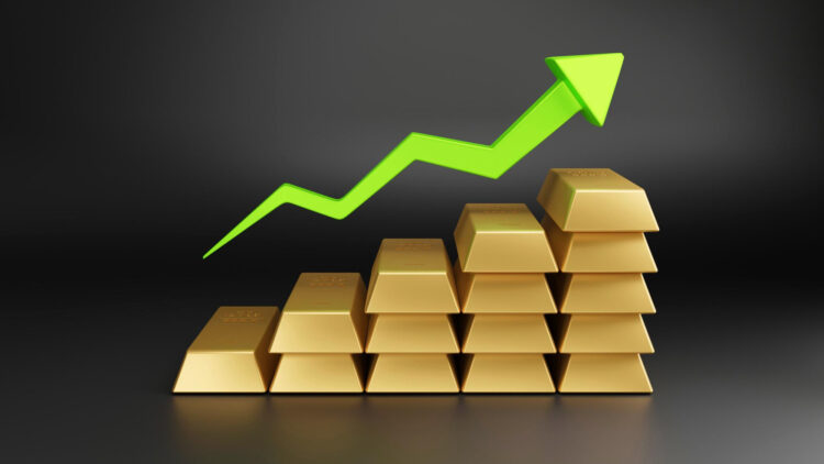 Stacks of gold bars arranged in ascending order with a bright green upward arrow above them, symbolizing growth or an increase in value. The background is dark and minimalistic. | FintechZoom