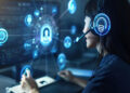 A woman wearing a headset works at a computer, surrounded by digital security and communication icons, representing technology, cybersecurity, and customer support in a futuristic setting. | FintechZoom