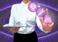 A person in a white shirt holds a tablet and touches floating purple icons, including a dollar sign in a lightbulb, a wrench, and people with a globe, with a digital abstract background. | FintechZoom