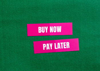 Two pink rectangles with white text on a green background. The top rectangle says "BUY NOW" and the bottom rectangle says "PAY LATER. | FintechZoom