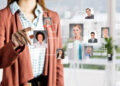 A woman in business attire touches floating portraits of diverse professionals connected by digital squares, representing networking or virtual team building, in a bright office setting. | FintechZoom