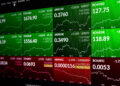 Cryptocurrency trading screen showing various digital currency pairs with green and red price charts, indicating market gains and losses. Coins include Bitcoin, Ethereum, XRP, and Bitcoin Cash. | FintechZoom